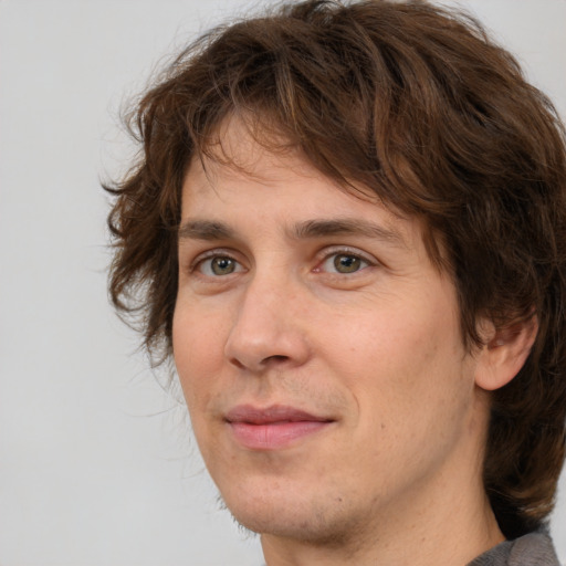 Joyful white adult male with medium  brown hair and brown eyes