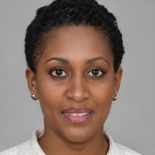 Joyful black young-adult female with short  brown hair and brown eyes