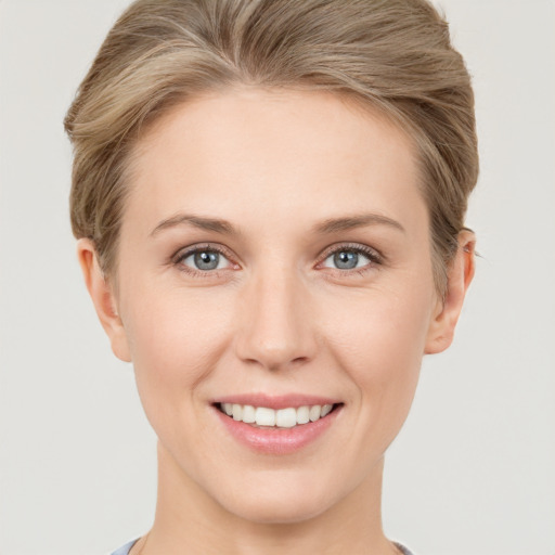 Joyful white young-adult female with short  brown hair and grey eyes