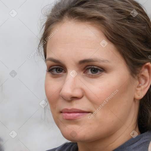 Joyful white adult female with medium  brown hair and blue eyes