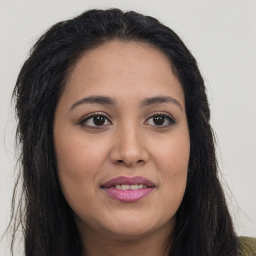 Joyful latino young-adult female with long  brown hair and brown eyes