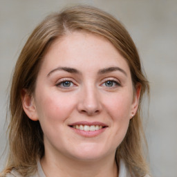 Joyful white young-adult female with medium  brown hair and blue eyes