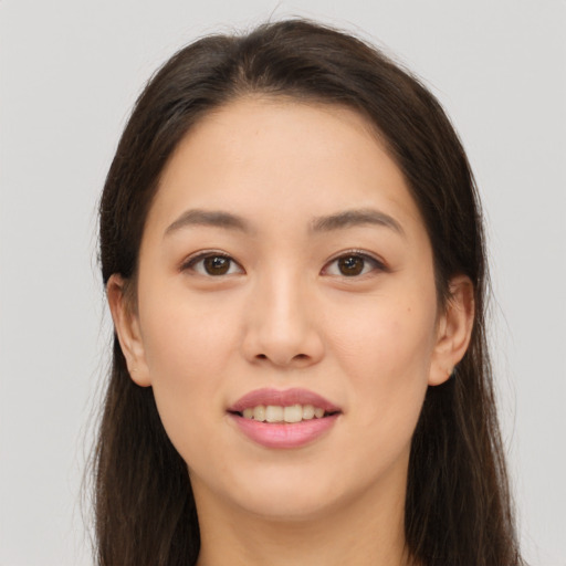 Joyful white young-adult female with long  brown hair and brown eyes