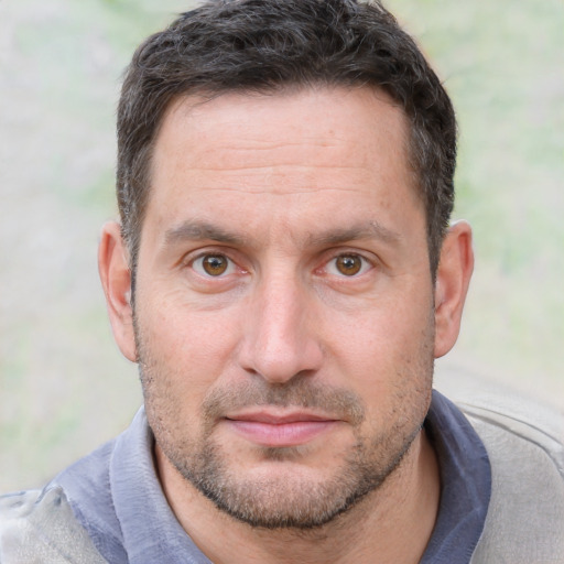 Joyful white adult male with short  brown hair and brown eyes