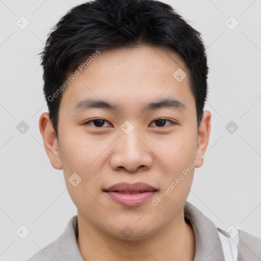 Joyful asian young-adult male with short  black hair and brown eyes