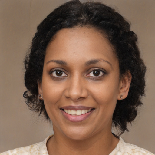 Joyful black young-adult female with medium  brown hair and brown eyes