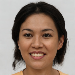 Joyful asian young-adult female with medium  brown hair and brown eyes