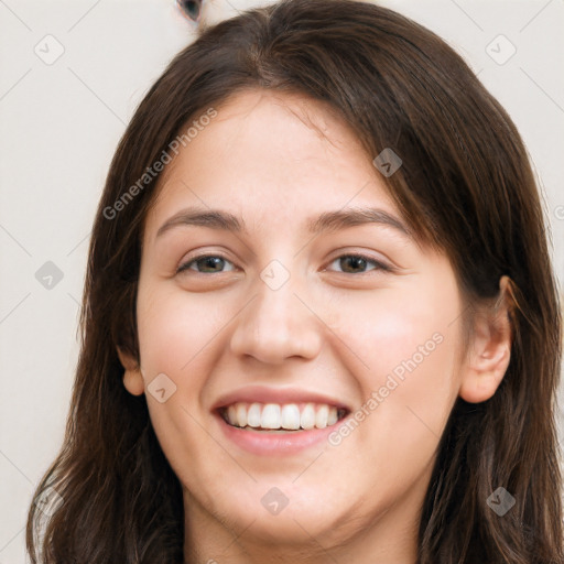 Joyful white young-adult female with long  brown hair and brown eyes