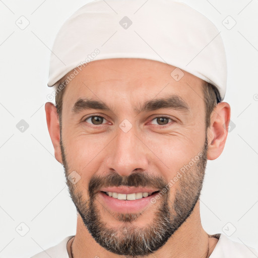 Joyful white young-adult male with short  black hair and brown eyes