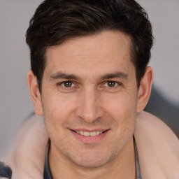 Joyful white adult male with short  brown hair and brown eyes