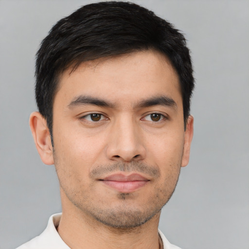 Joyful white young-adult male with short  black hair and brown eyes