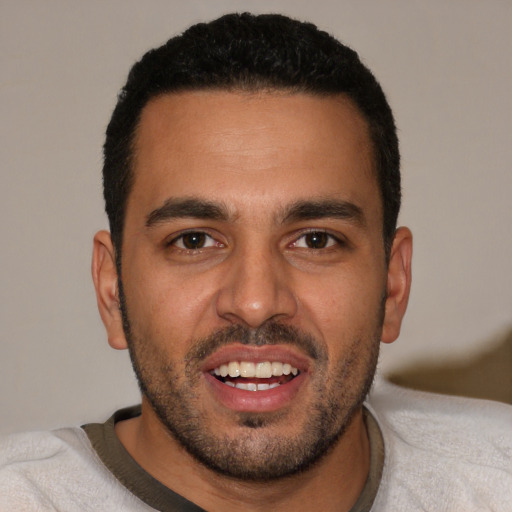 Joyful white young-adult male with short  black hair and brown eyes