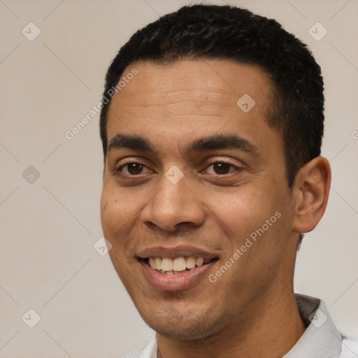 Joyful white young-adult male with short  black hair and brown eyes