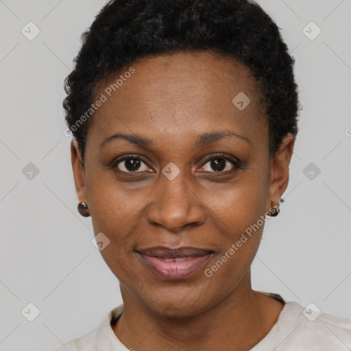 Joyful black adult female with short  black hair and brown eyes