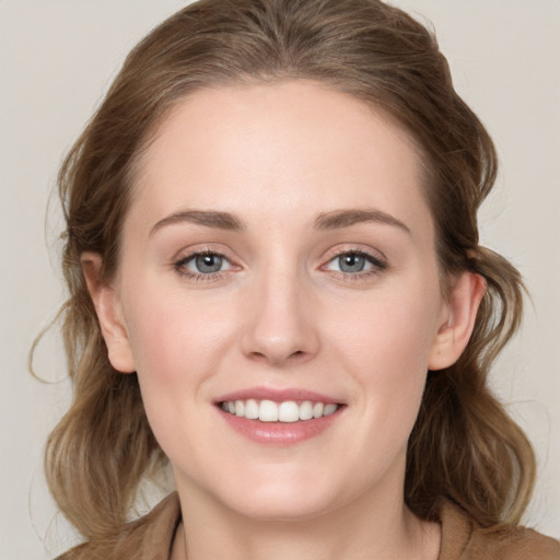 Joyful white young-adult female with long  brown hair and grey eyes