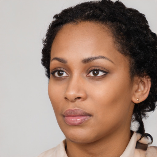 Neutral black young-adult female with medium  black hair and brown eyes