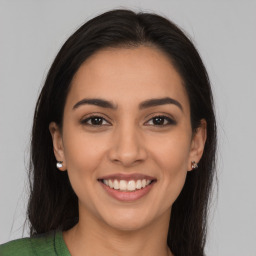 Joyful latino young-adult female with long  brown hair and brown eyes