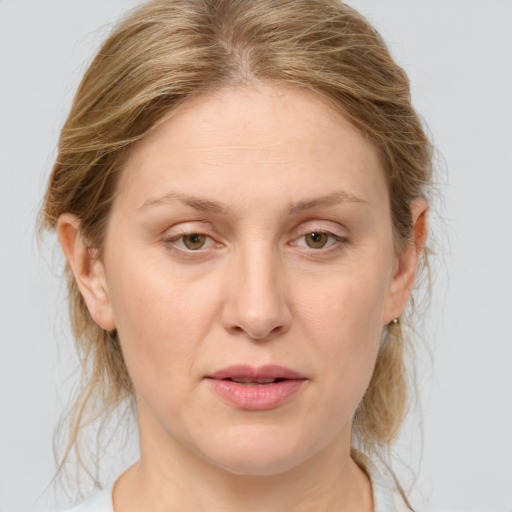 Joyful white adult female with medium  brown hair and blue eyes