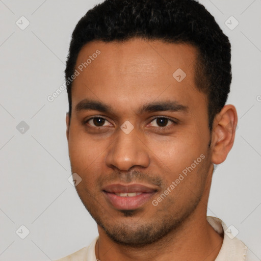 Joyful black young-adult male with short  black hair and brown eyes