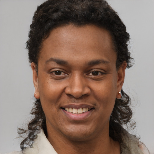 Joyful black young-adult female with short  black hair and brown eyes