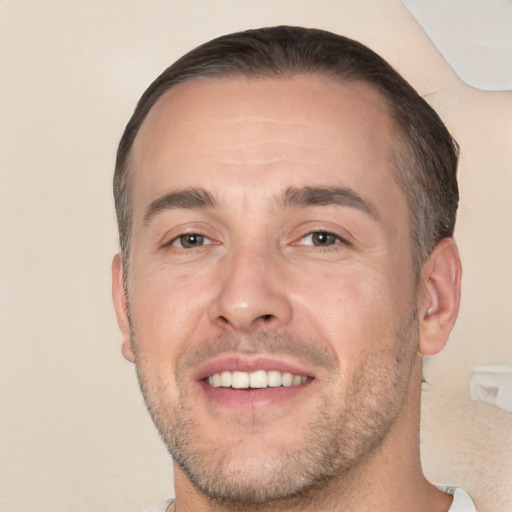 Joyful white adult male with short  brown hair and brown eyes