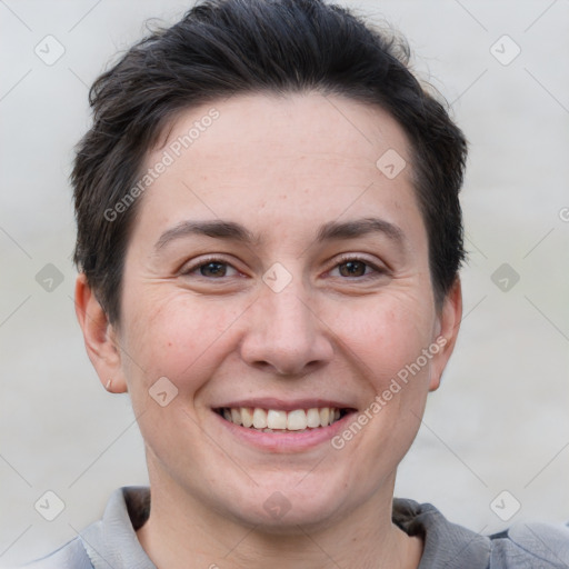 Joyful white adult female with short  brown hair and brown eyes