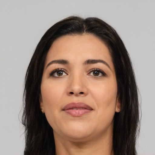 Joyful latino young-adult female with long  brown hair and brown eyes