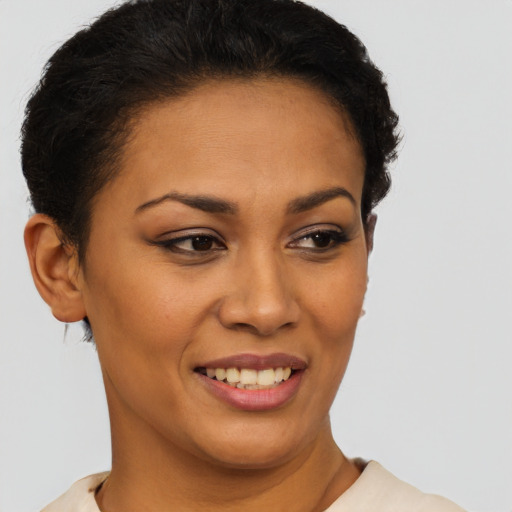 Joyful latino young-adult female with short  brown hair and brown eyes