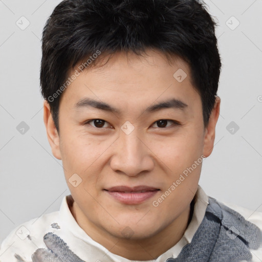 Joyful asian young-adult male with short  brown hair and brown eyes