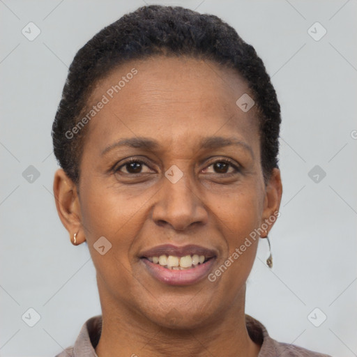 Joyful black adult female with short  brown hair and brown eyes