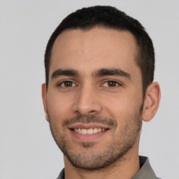 Joyful white young-adult male with short  brown hair and brown eyes