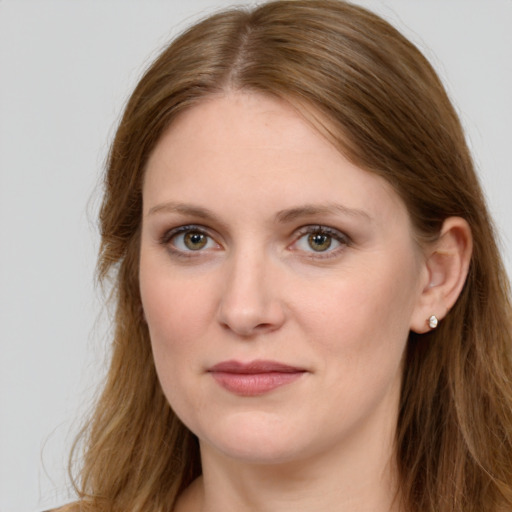 Joyful white young-adult female with long  brown hair and blue eyes