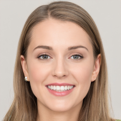 Joyful white young-adult female with long  brown hair and grey eyes