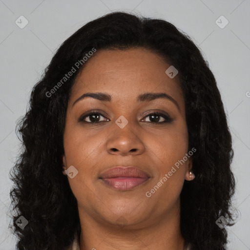 Joyful black adult female with long  brown hair and brown eyes