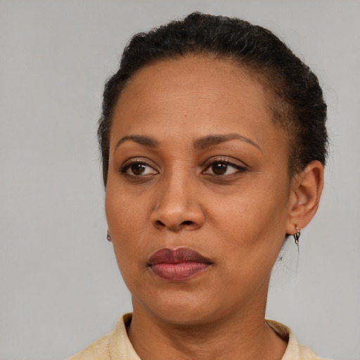 Neutral latino adult female with short  brown hair and brown eyes