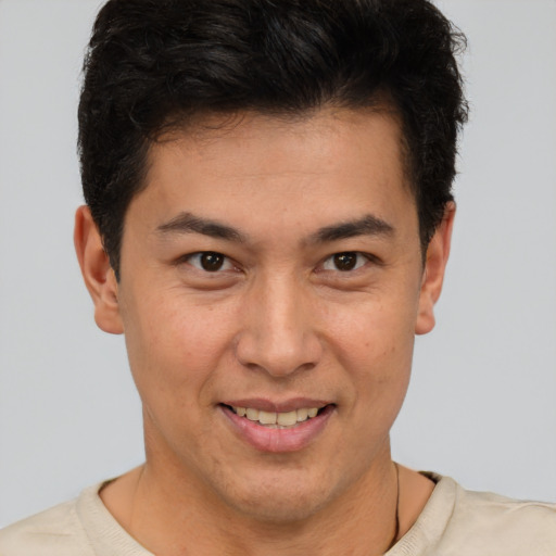 Joyful latino young-adult male with short  brown hair and brown eyes