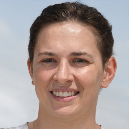 Joyful white adult female with short  brown hair and brown eyes