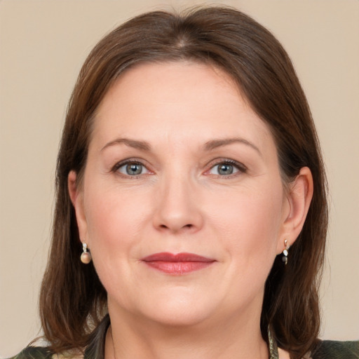 Joyful white adult female with medium  brown hair and grey eyes