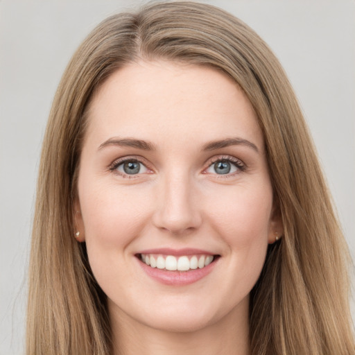 Joyful white young-adult female with long  brown hair and green eyes