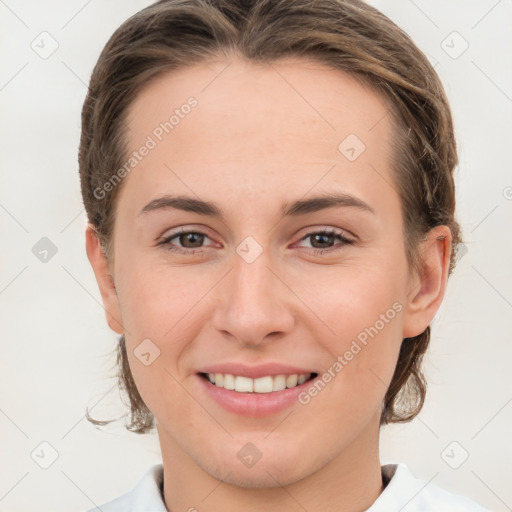 Joyful white young-adult female with medium  brown hair and grey eyes