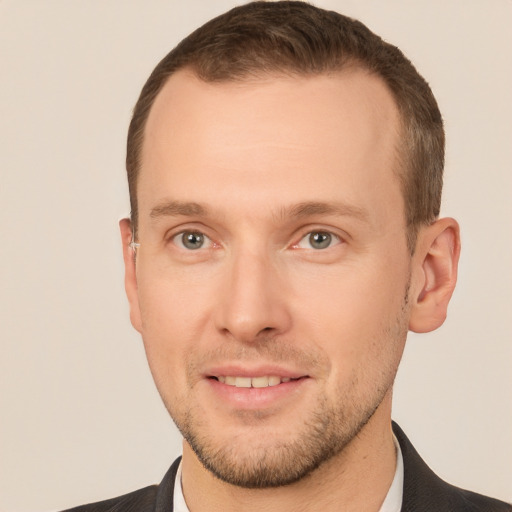 Joyful white adult male with short  brown hair and brown eyes