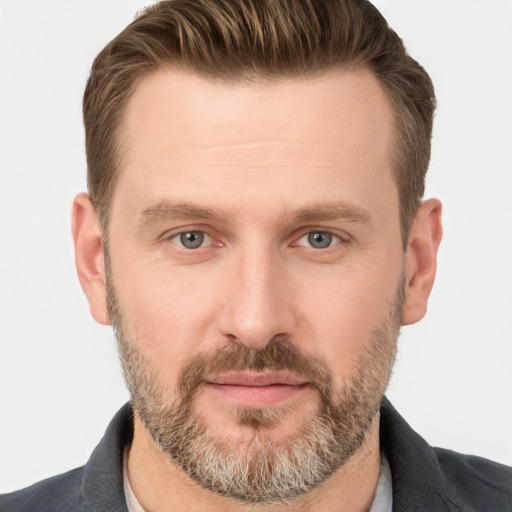 Joyful white adult male with short  brown hair and grey eyes