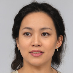 Joyful asian young-adult female with medium  brown hair and brown eyes