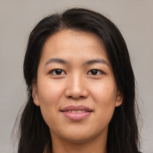 Joyful asian young-adult female with long  brown hair and brown eyes
