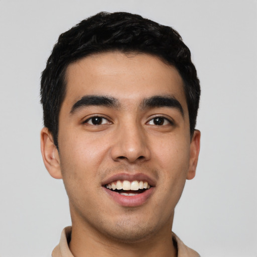 Joyful latino young-adult male with short  black hair and brown eyes