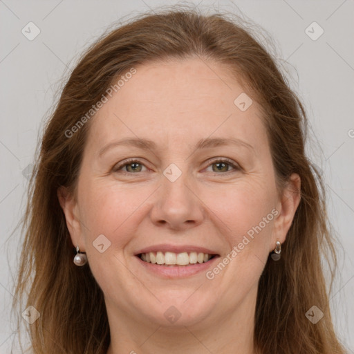 Joyful white adult female with long  brown hair and grey eyes