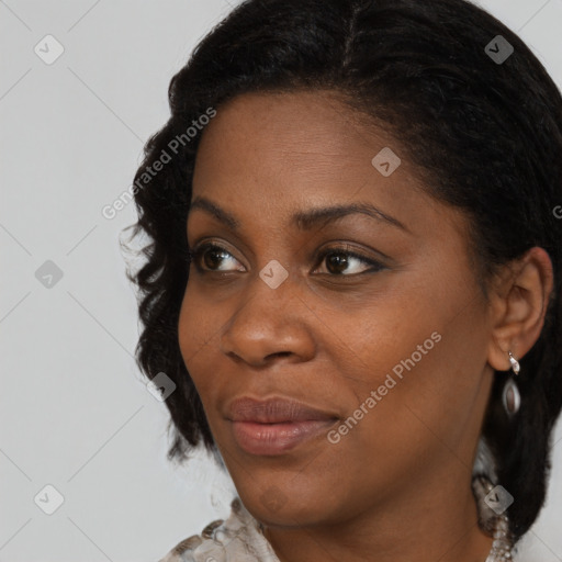 Joyful black adult female with medium  brown hair and brown eyes