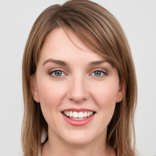 Joyful white young-adult female with long  brown hair and green eyes