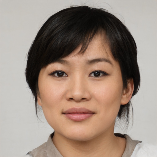 Joyful white young-adult female with medium  black hair and brown eyes