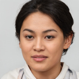 Joyful latino young-adult female with medium  brown hair and brown eyes